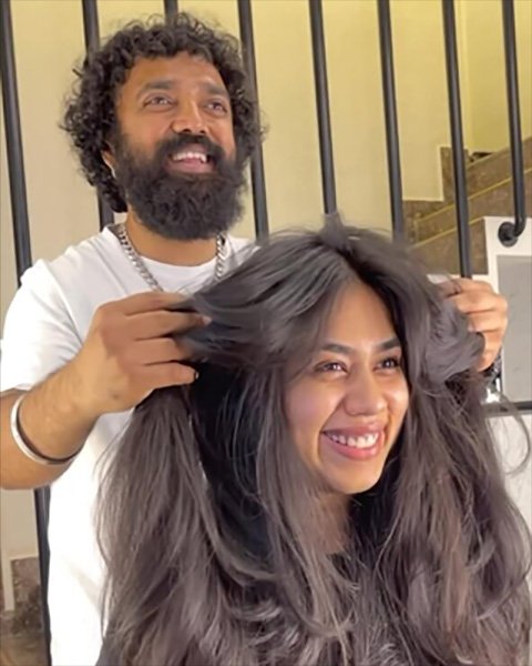Expert stylist with a client showcasing long, healthy, voluminous hair at Artysto Salon, the best unisex parlour near me in Coimbatore.