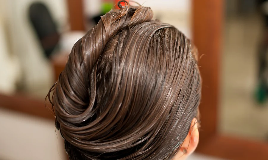 Client receiving a Cysteine Treatment at Artysto Salon to deeply nourish and smooth hair while eliminating frizz.