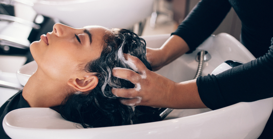 Client receiving a Deep Purifying Scalp Treatment at Artysto Salon, featuring a professional hair wash and scalp massage.