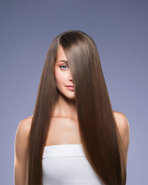 Woman with ultra-smooth, shiny, and frizz-free hair, showing the perfect result of Artysto Nanoplastia Treatment.