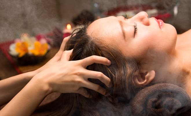 Client receiving a Scalp Soothing Treatment massage with steam, promoting relaxation and tension relief at Artysto Salon.