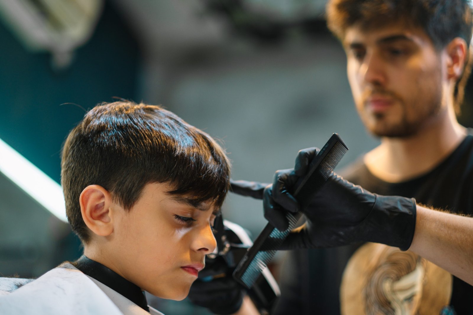 professional Artysto stylist meticulously cutting and styling a client's hair with scissors.