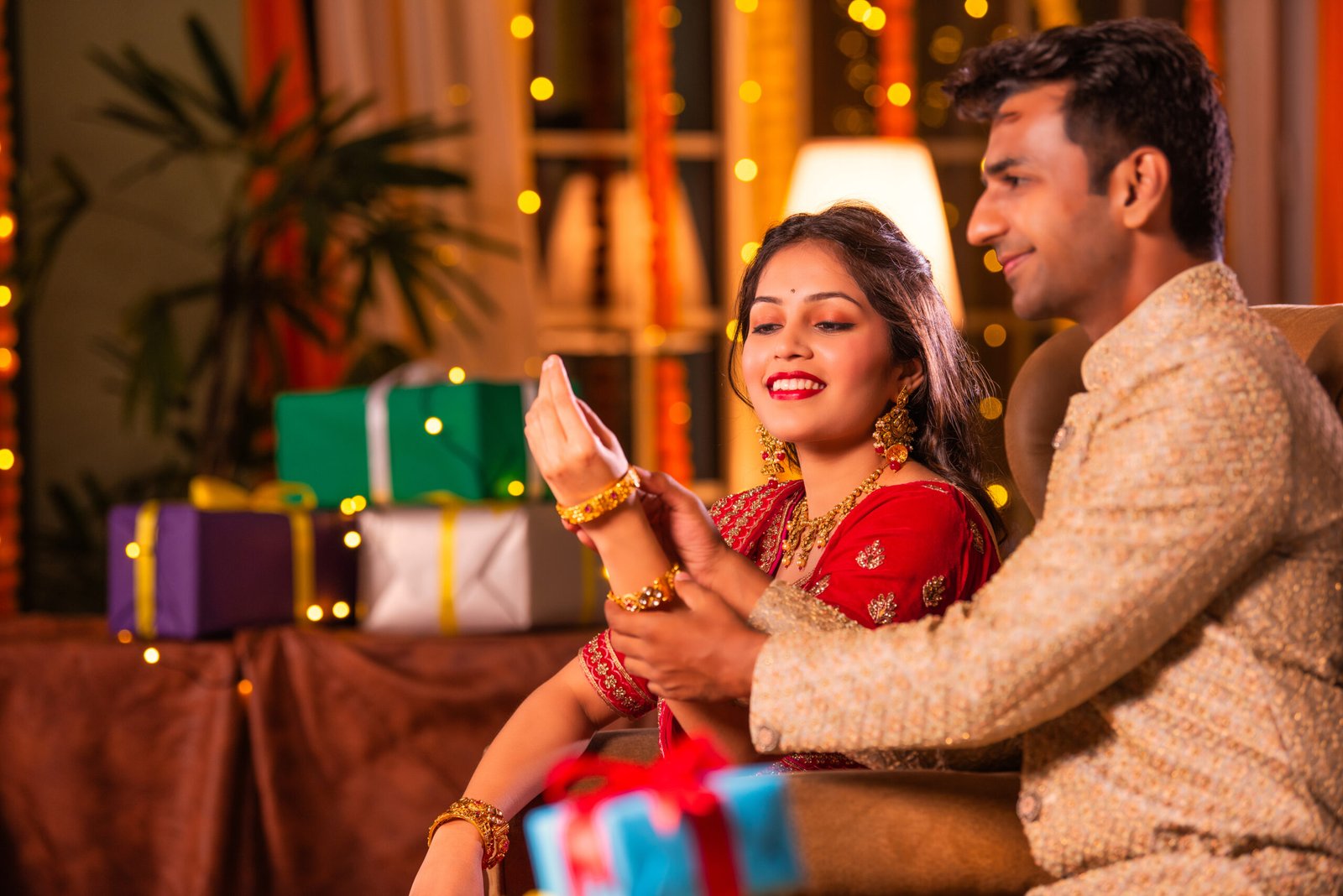 Engaged couple at a reception, the woman wearing glamorous Engagement Makeup with radiant skin and defined features.