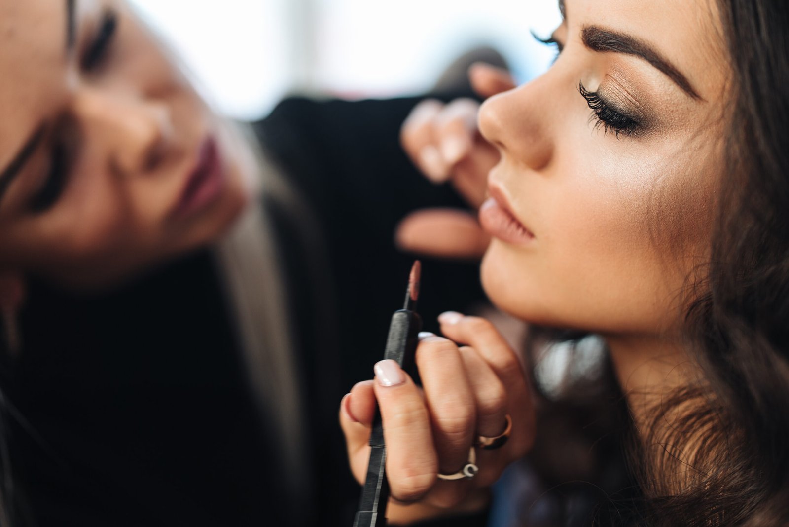 Makeup artist applying a natural, light makeup look for a daytime event, resulting in a subtle, radiant, and polished finish.