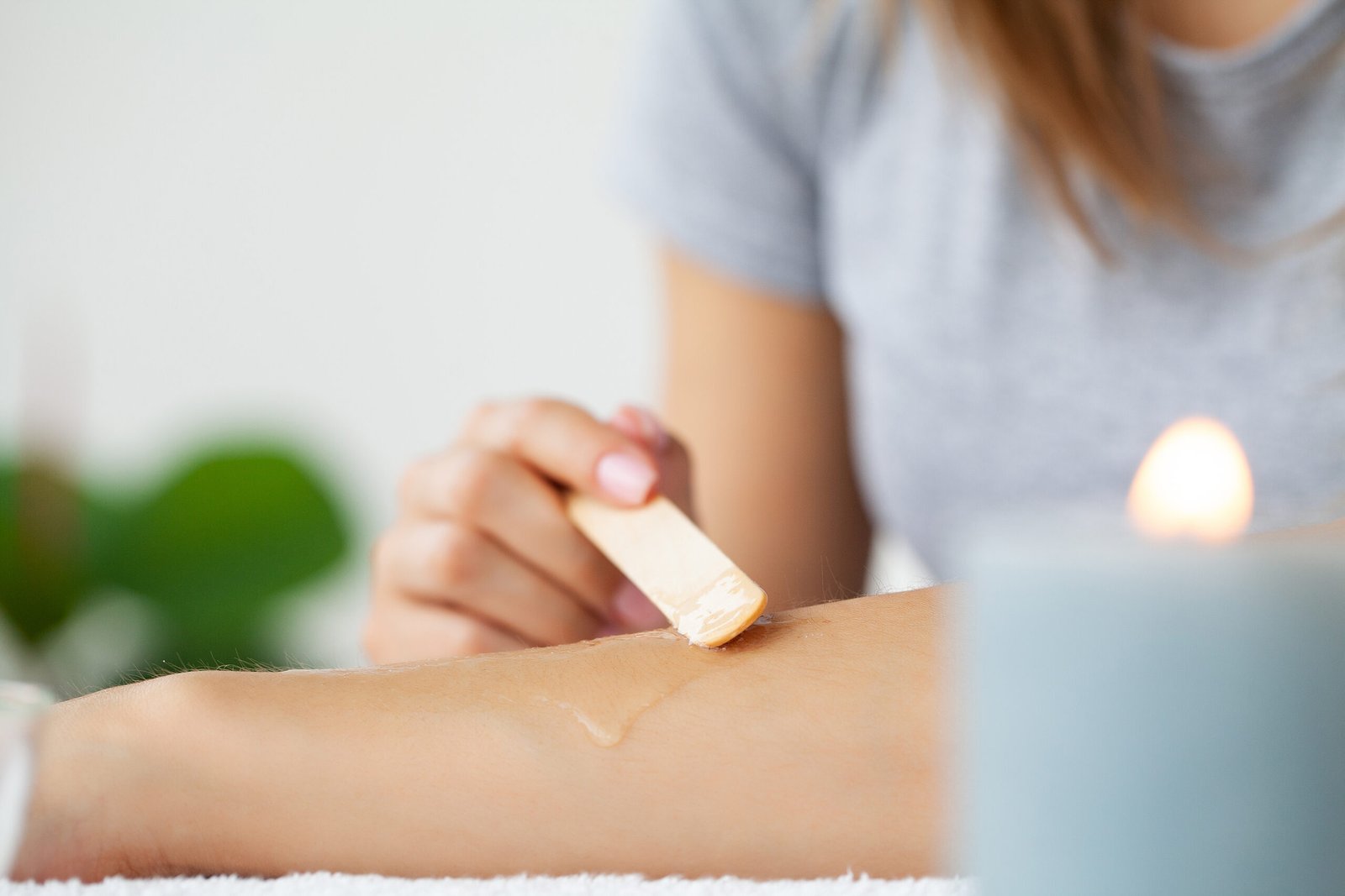 Professional technician performing gentle sugaring hair removal for Full Arms Waxing, ensuring silky smooth, hair-free skin.