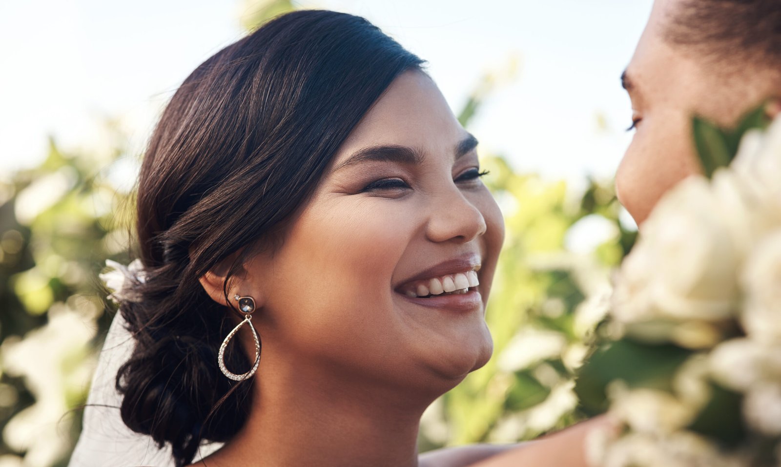 Happy bride with radiant, long-lasting wedding makeup and elegant styling on her special day, capturing searches for bridal looks.