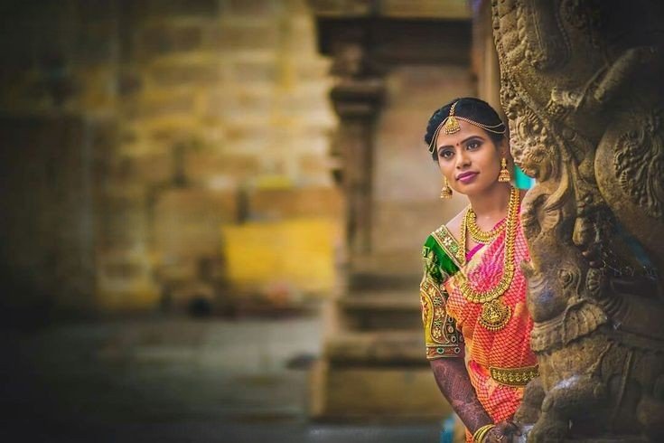 A bridal girl standing in a temple after bridal makeup in coimbatore - Artysto Salon